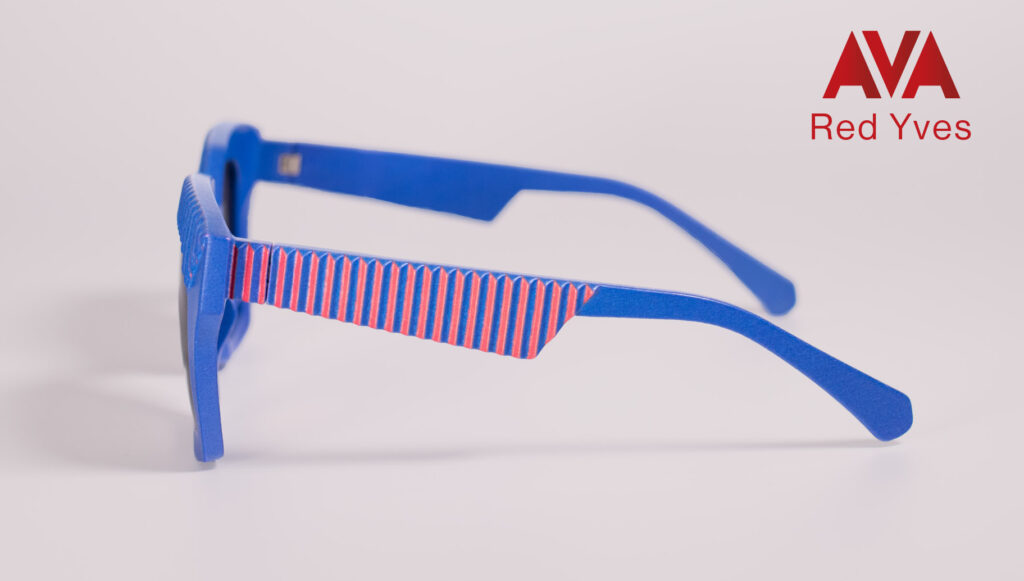 Side view of AVA Red Yves sunglasses by CEHO Studio, featuring a bold blue frame with red-striped temple detailing.