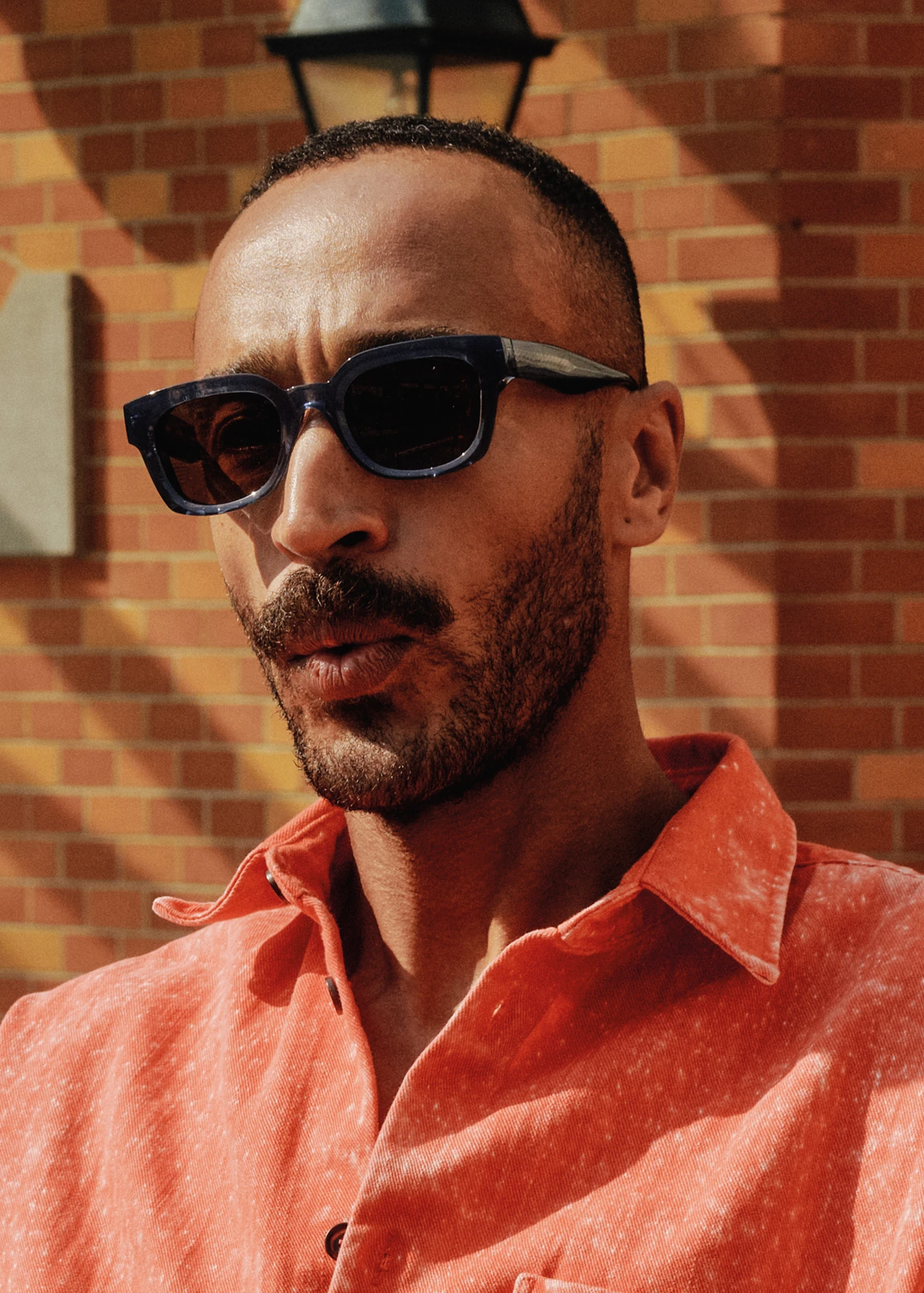 Dick Moby sunglasses worn with an orange shirt