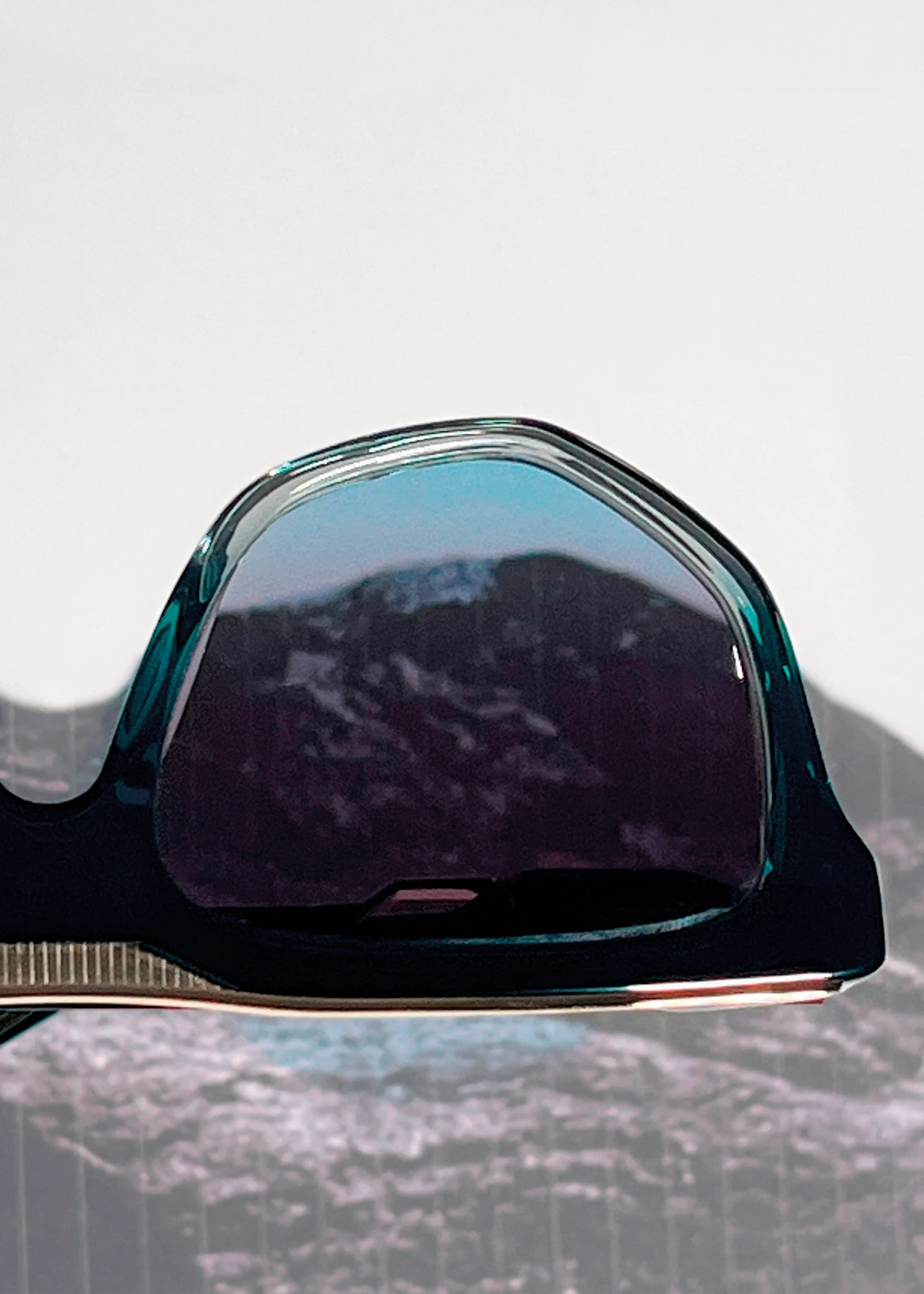 Einstoffen Ætherra sunglasses with a mountain reflected in the blue lens