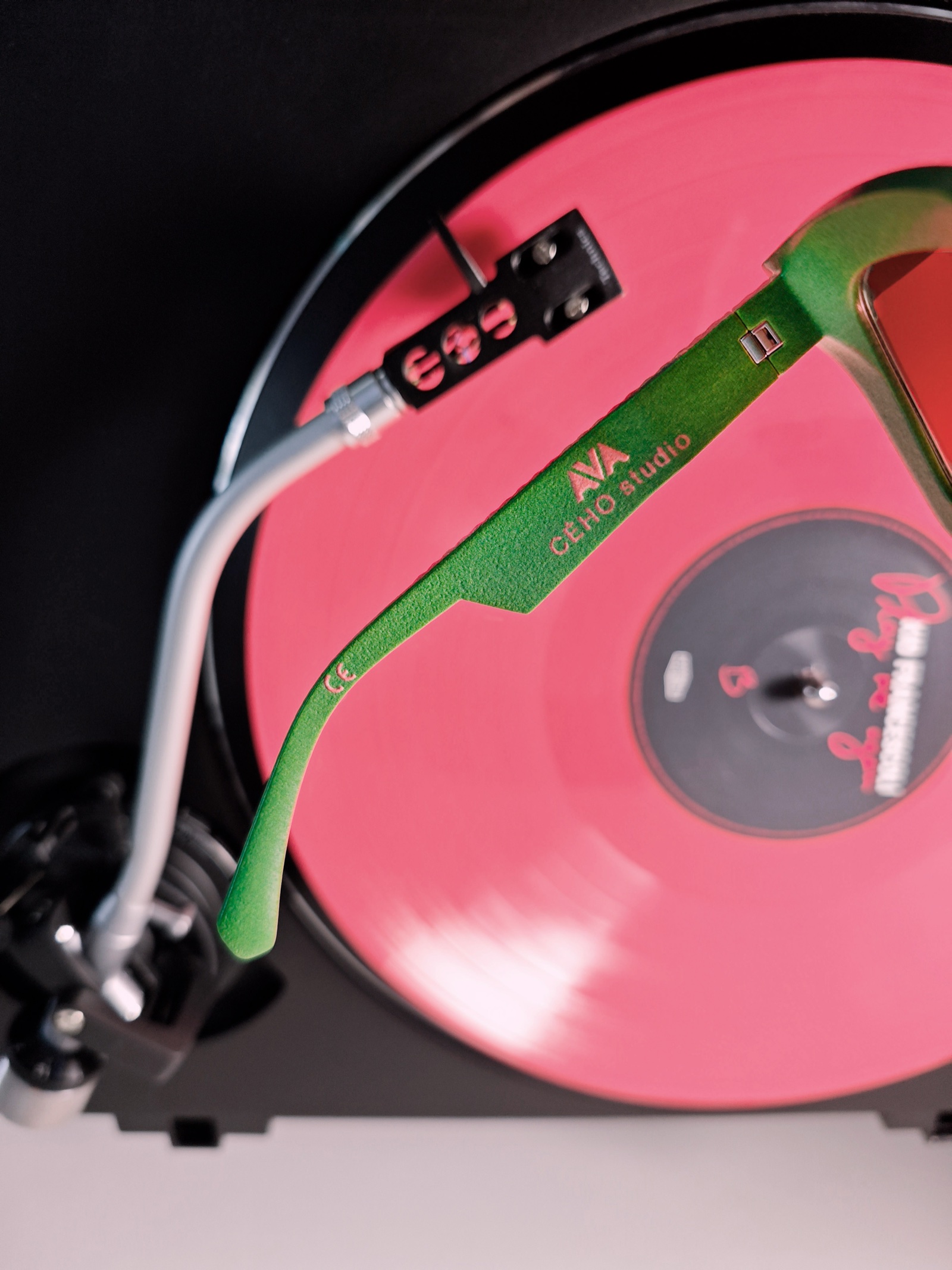 AVA Pink Jungle sunglasses photographed with a vinyl record