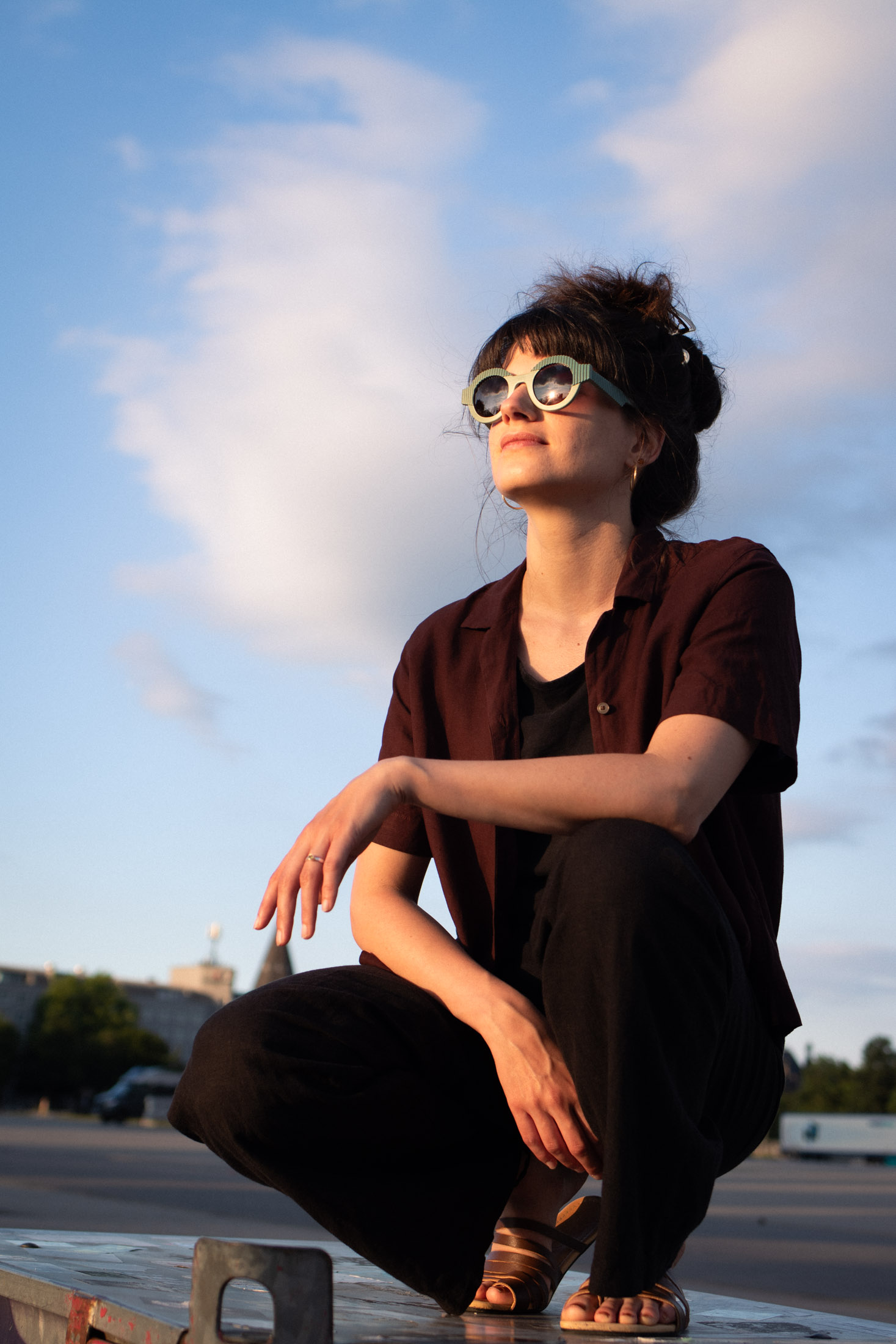 Mira wearing CÉHO studio OYA sage and teal sunglasses